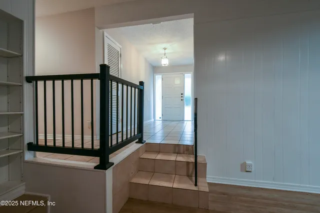 a view of staircase with white walls and a window