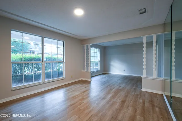 wooden floor in an empty room with a window