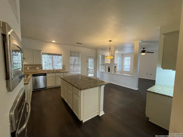 a kitchen with stainless steel appliances granite countertop a stove and a refrigerator