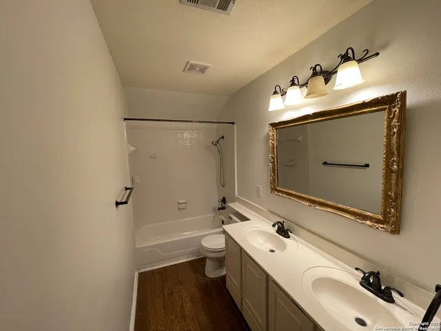 a bathroom with a sink mirror toilet and bathtub