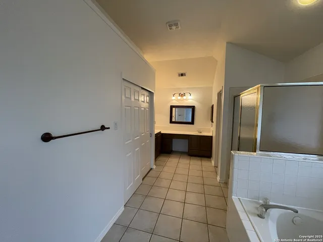 a view of a bathroom with a bathtub and a shower