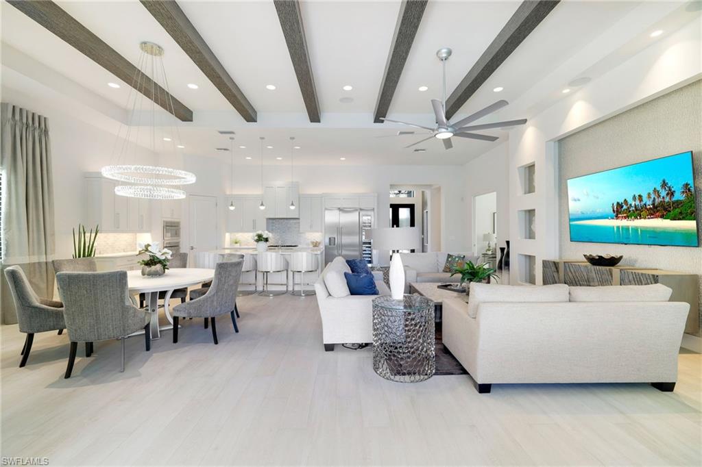 18488 Miromar Lakes Boulevard Miromar Lakes, FL 33913 - Photo 12 of 48 a living room with furniture and a flat screen tv