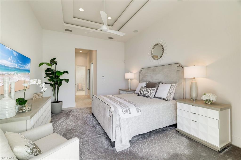 18488 Miromar Lakes Boulevard Miromar Lakes, FL 33913 - Photo 16 of 48 a bed room with a bed and a potted plant