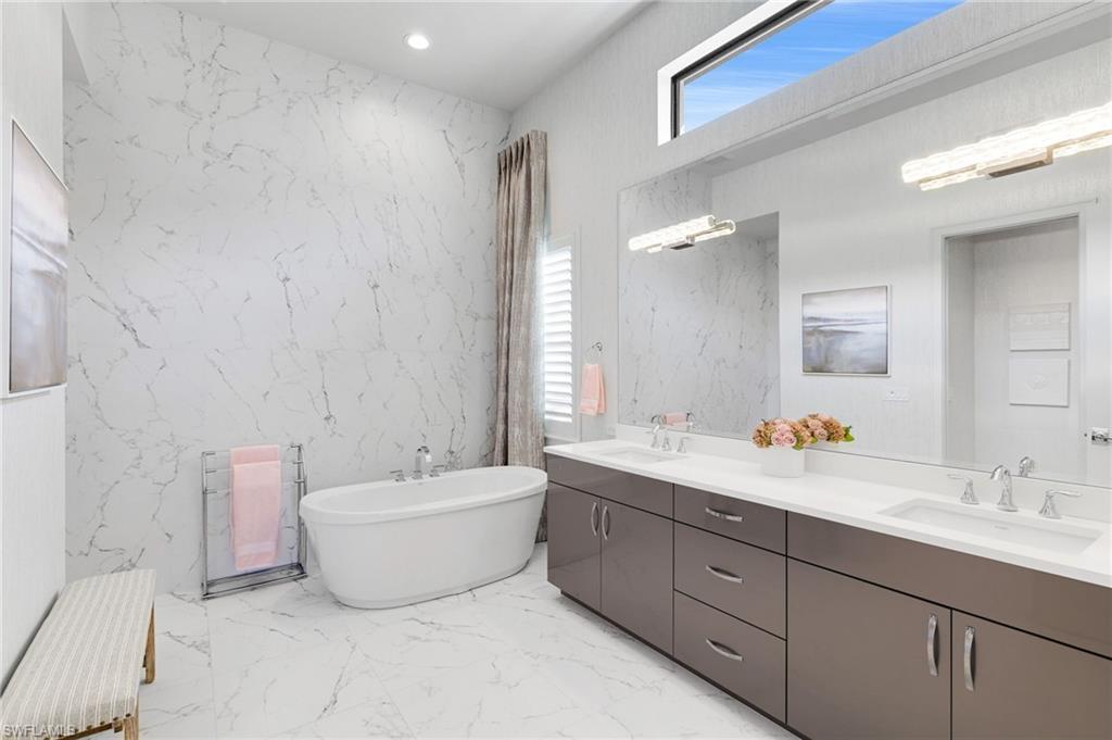 18488 Miromar Lakes Boulevard Miromar Lakes, FL 33913 - Photo 17 of 48 a spacious bathroom with a double vanity sink mirror and bathtub