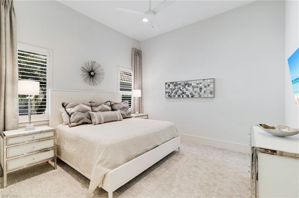 18488 Miromar Lakes Boulevard Miromar Lakes, FL 33913 - Photo 19 of 48 a bedroom with a bed and a cabinets