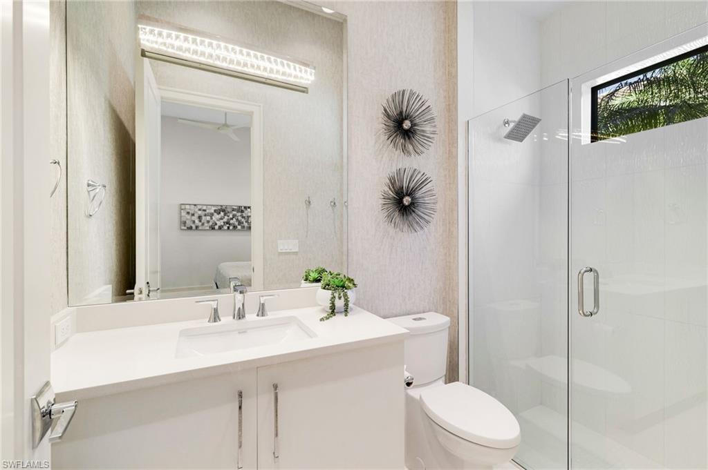 18488 Miromar Lakes Boulevard Miromar Lakes, FL 33913 - Photo 20 of 48 a bathroom with a sink toilet and shower