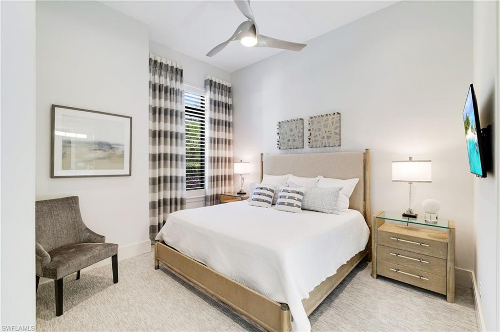 18488 Miromar Lakes Boulevard Miromar Lakes, FL 33913 - Photo 21 of 48 a bedroom with a bed and a chair