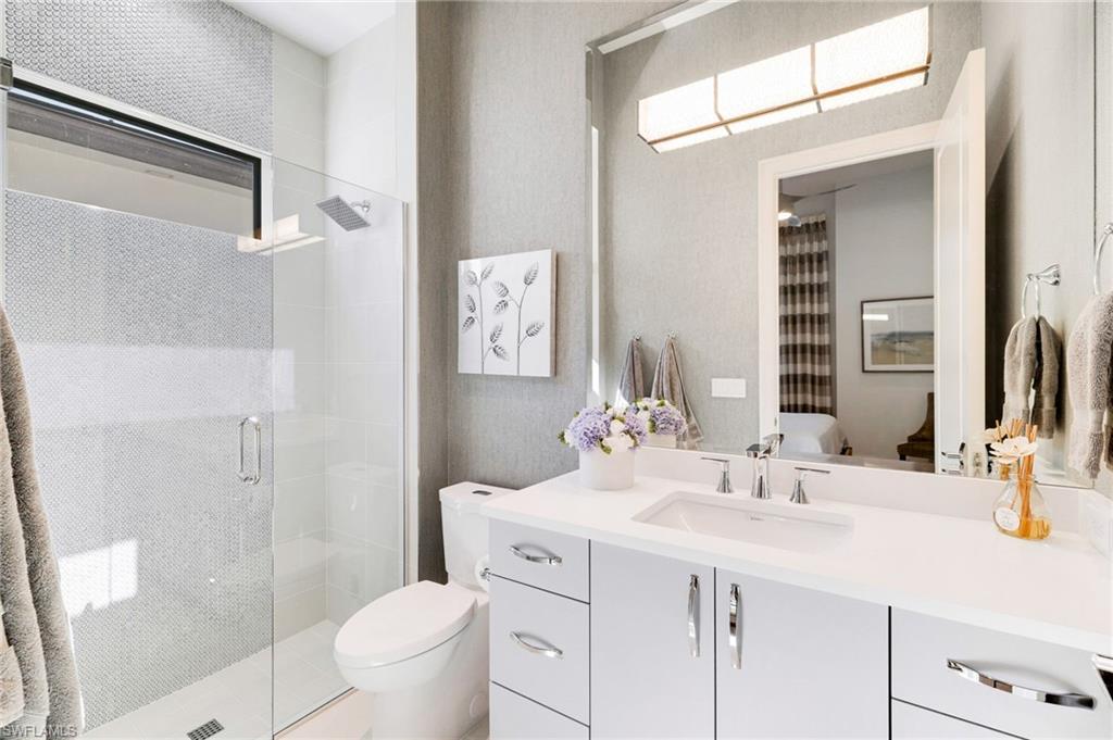 18488 Miromar Lakes Boulevard Miromar Lakes, FL 33913 - Photo 22 of 48 a bathroom with a sink and a mirror