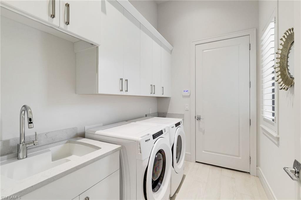 18488 Miromar Lakes Boulevard Miromar Lakes, FL 33913 - Photo 24 of 48 a utility room with dryer and washer