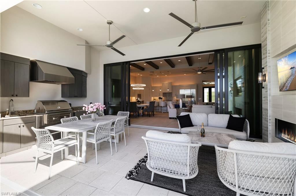 18488 Miromar Lakes Boulevard Miromar Lakes, FL 33913 - Photo 27 of 48 a living room with lots of furniture and a large window
