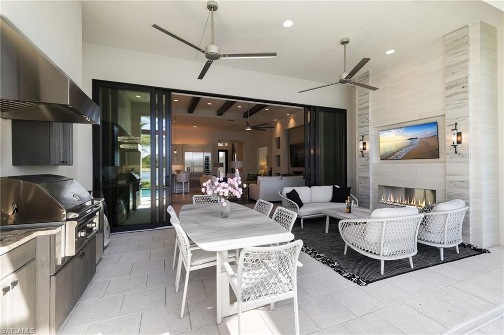 18488 Miromar Lakes Boulevard Miromar Lakes, FL 33913 - Photo 28 of 48 a living room with furniture a flat screen tv and a window