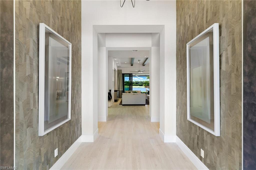 18488 Miromar Lakes Boulevard Miromar Lakes, FL 33913 - Photo 3 of 48 a view of a bedroom from a hallway