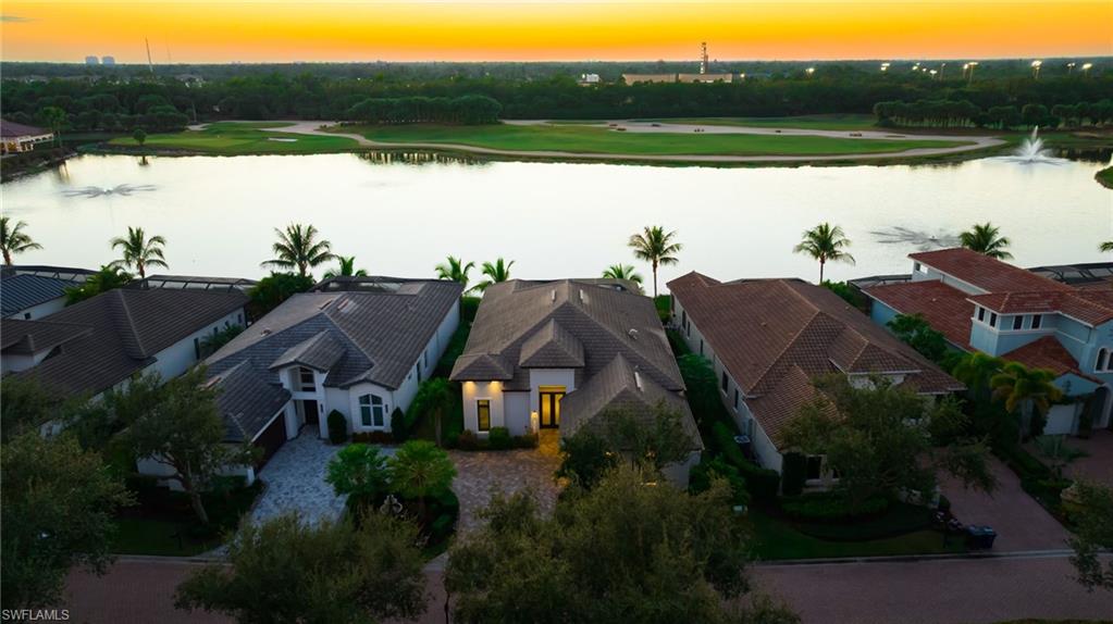 18488 Miromar Lakes Boulevard Miromar Lakes, FL 33913 - Photo 34 of 48 a view of a house with a yard and lake view