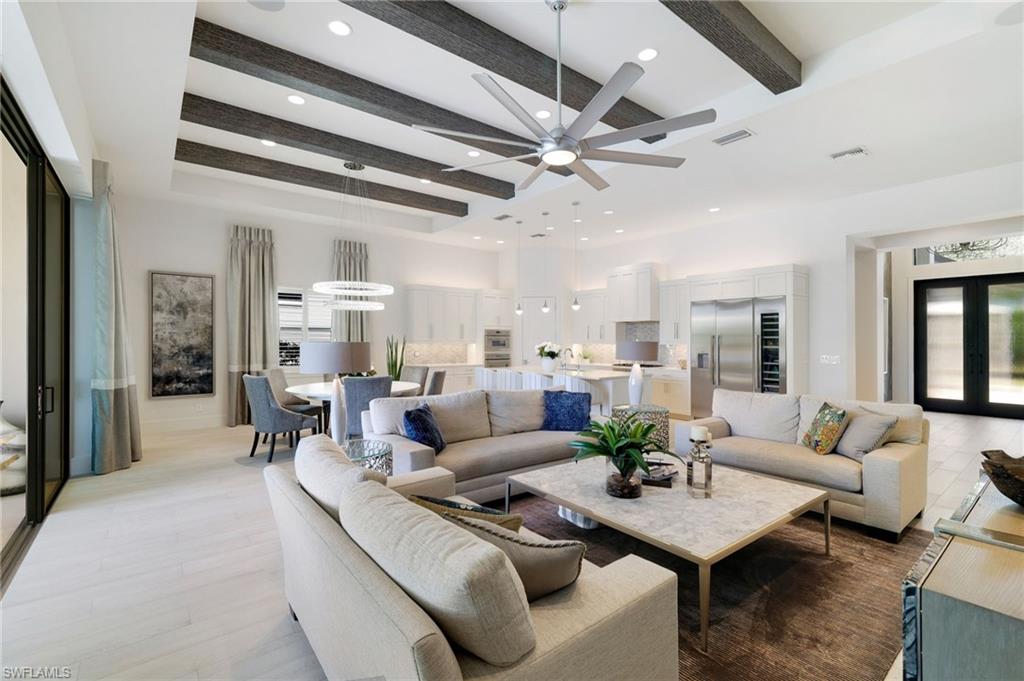 18488 Miromar Lakes Boulevard Miromar Lakes, FL 33913 - Photo 4 of 48 a living room with furniture and a chandelier