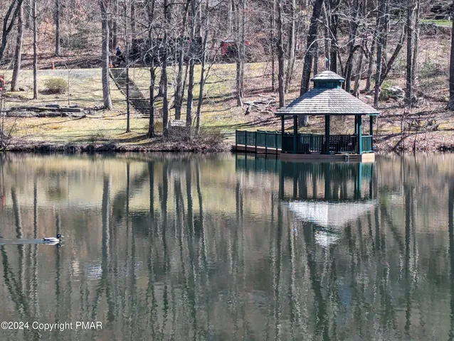 a view of a lake with sitting area