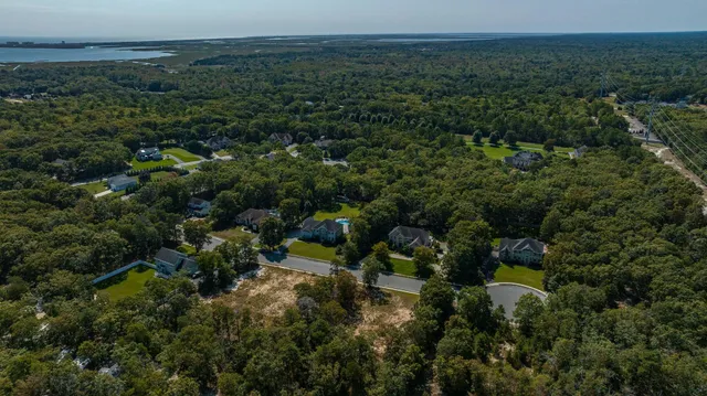 an aerial view of a houses with a yard