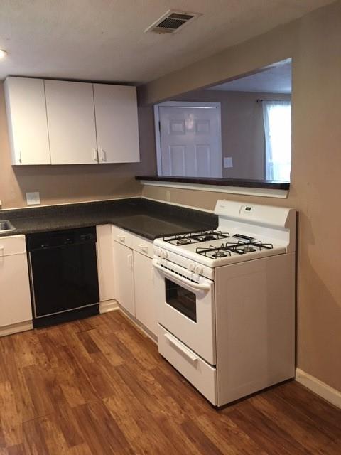 4410 Bonham Street Dallas, TX 75229 - Photo 3 of 14 a kitchen with granite countertop a stove and a sink