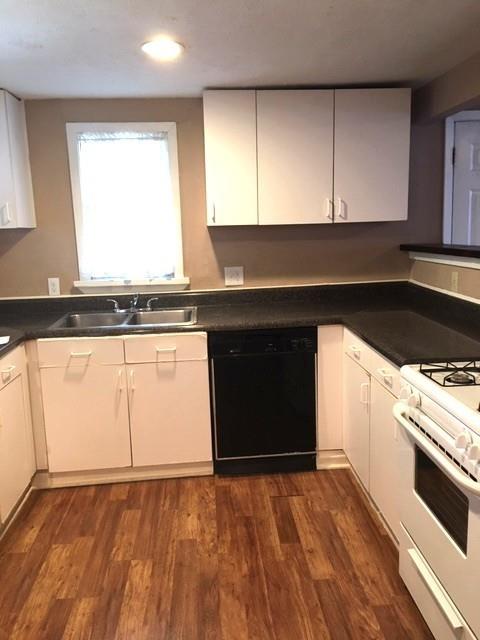 4410 Bonham Street Dallas, TX 75229 - Photo 4 of 14 a kitchen with granite countertop a stove a sink and a microwave