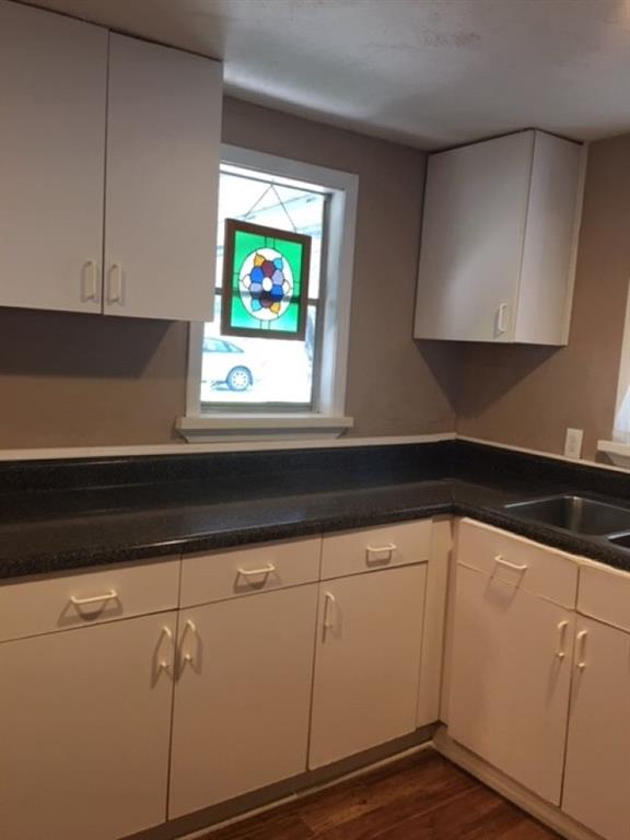 4410 Bonham Street Dallas, TX 75229 - Photo 6 of 14 a kitchen with white cabinets and sink