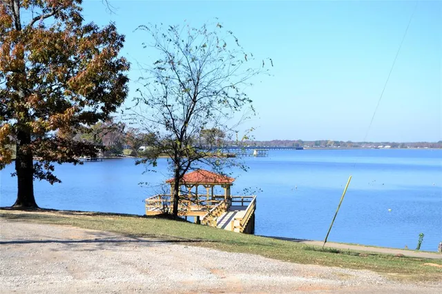 a view of swimming pool with outdoor seating and yard in the back