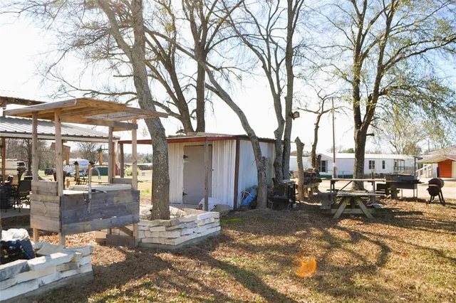 a view of a house with backyard and sitting area