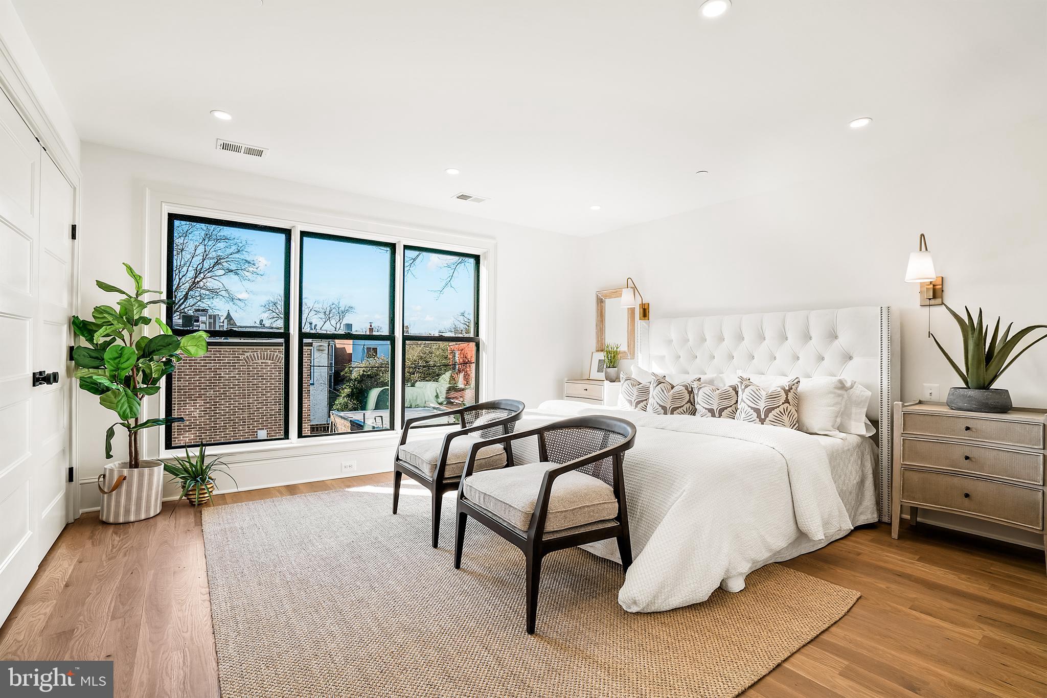 240 11th Street Northeast Washington, DC 20002 - Photo 11 of 32 a spacious bedroom with a bed and a large window