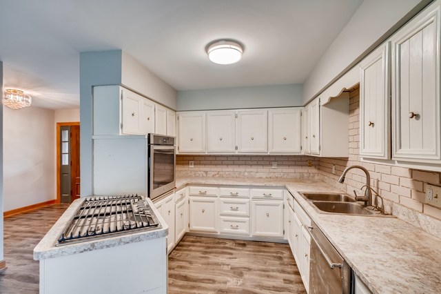 1331 West Maple Road New Lenox, IL 60451 - Photo 7 of 17 a kitchen with stainless steel appliances granite countertop a sink stove and refrigerator