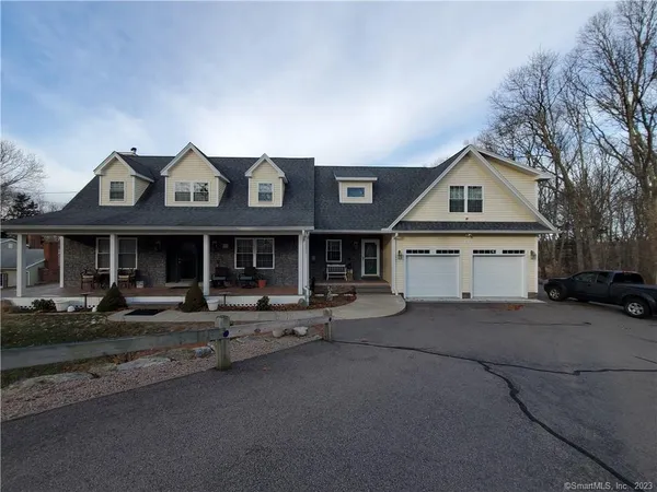 a view of a house with a yard and garage