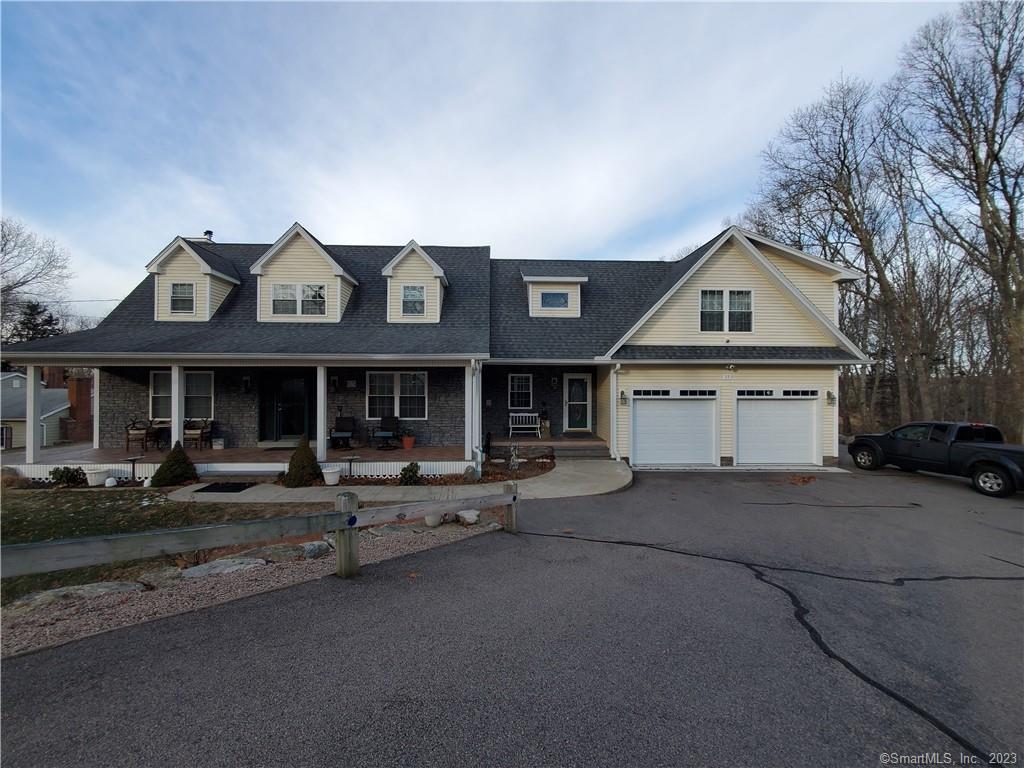 a view of a house with a yard and garage