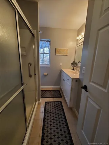 a bathroom with sink toilet and shower