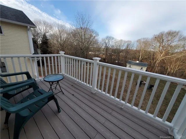 a view of balcony with wooden floor and outdoor seating