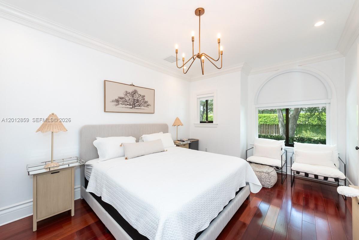 12311 Southwest 94th Avenue Miami, FL 33176 - Photo 19 of 32 a spacious bedroom with a bed and a chandelier