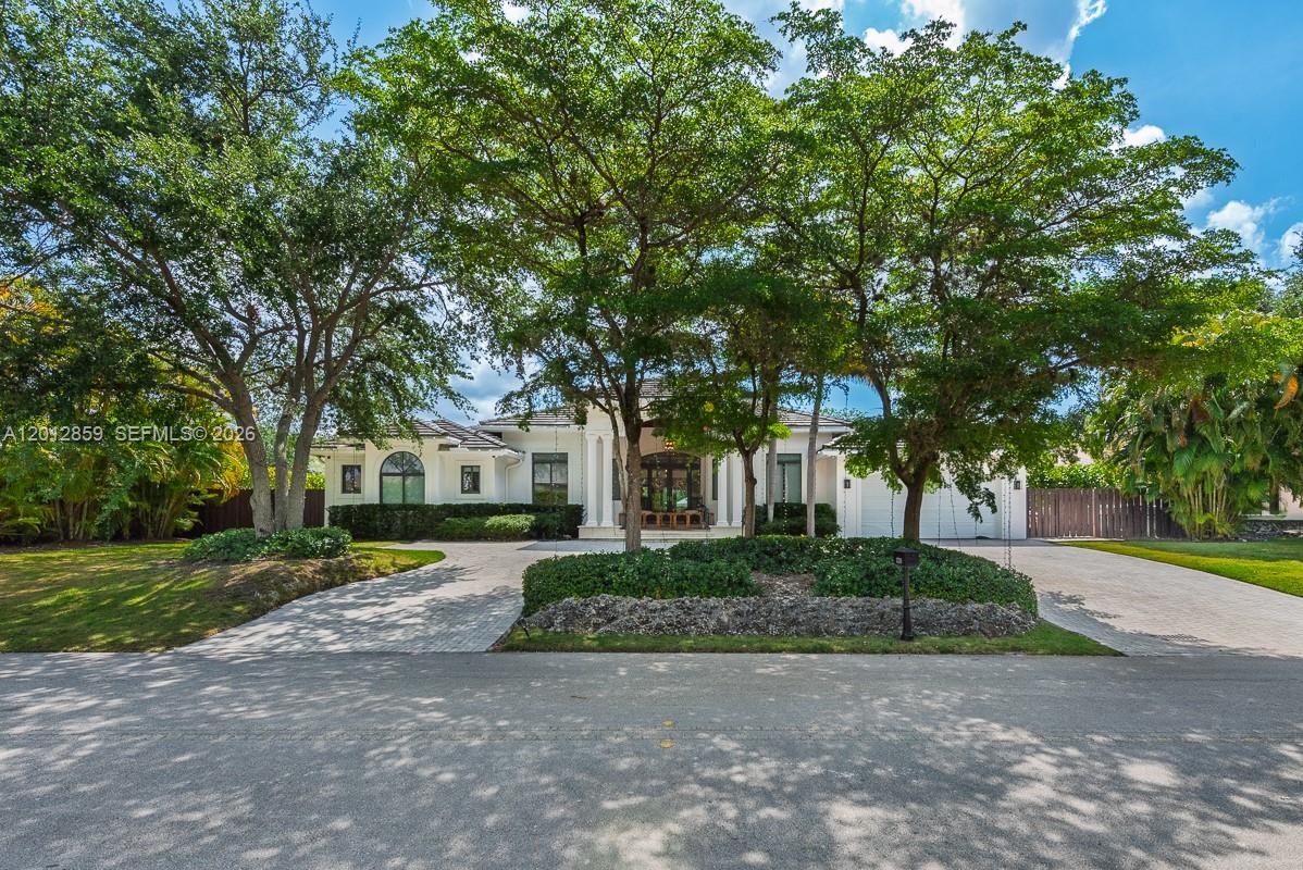 12311 Southwest 94th Avenue Miami, FL 33176 - Photo 2 of 32 a front view of a house with a yard and trees