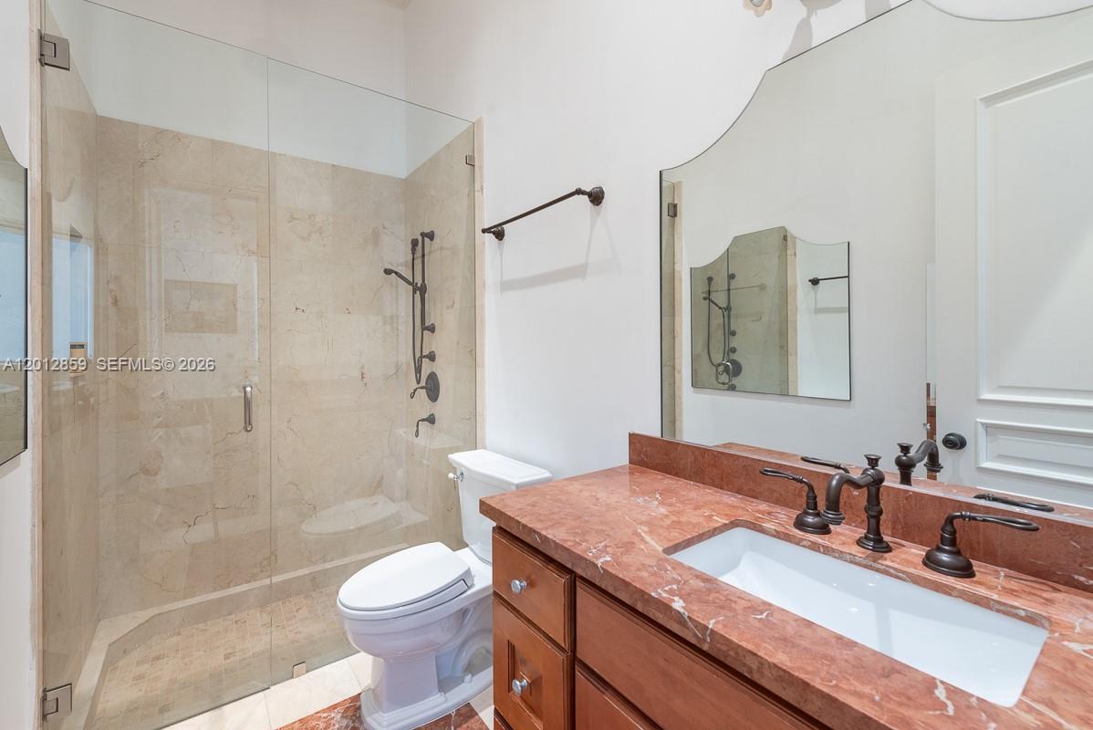 12311 Southwest 94th Avenue Miami, FL 33176 - Photo 23 of 32 a bathroom with a granite countertop sink toilet and shower