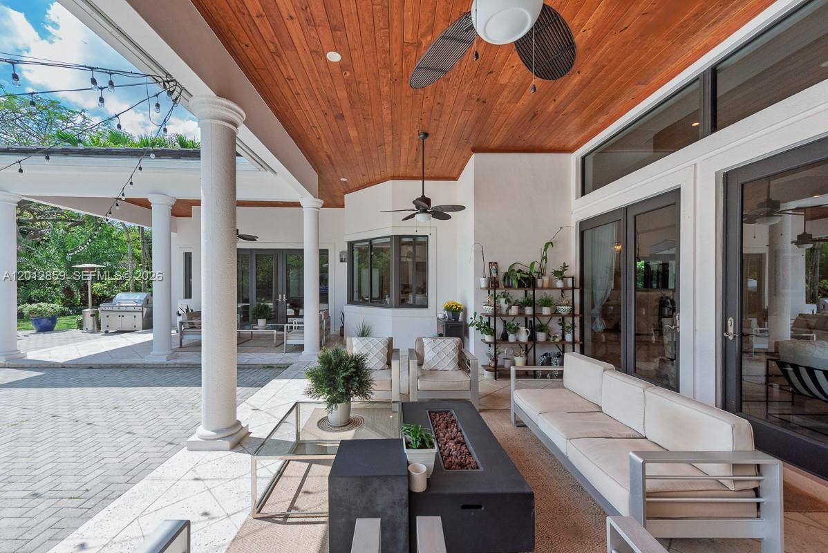 12311 Southwest 94th Avenue Miami, FL 33176 - Photo 25 of 32 a view of a patio with couches table and chairs and potted plants