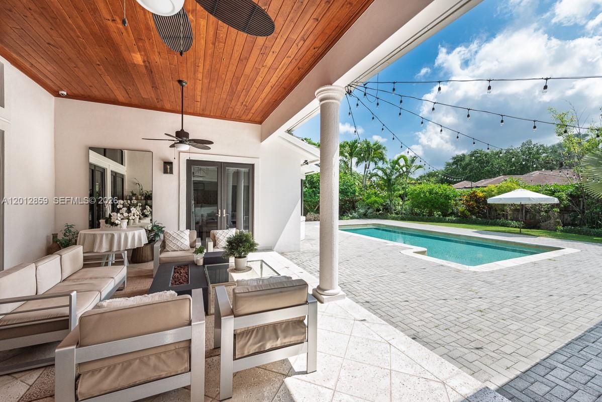 12311 Southwest 94th Avenue Miami, FL 33176 - Photo 26 of 32 a view of a patio with couches table and chairs and potted plants