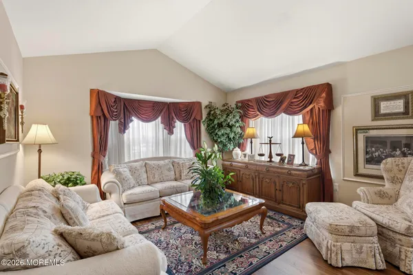 a living room with fireplace furniture and a wooden floor