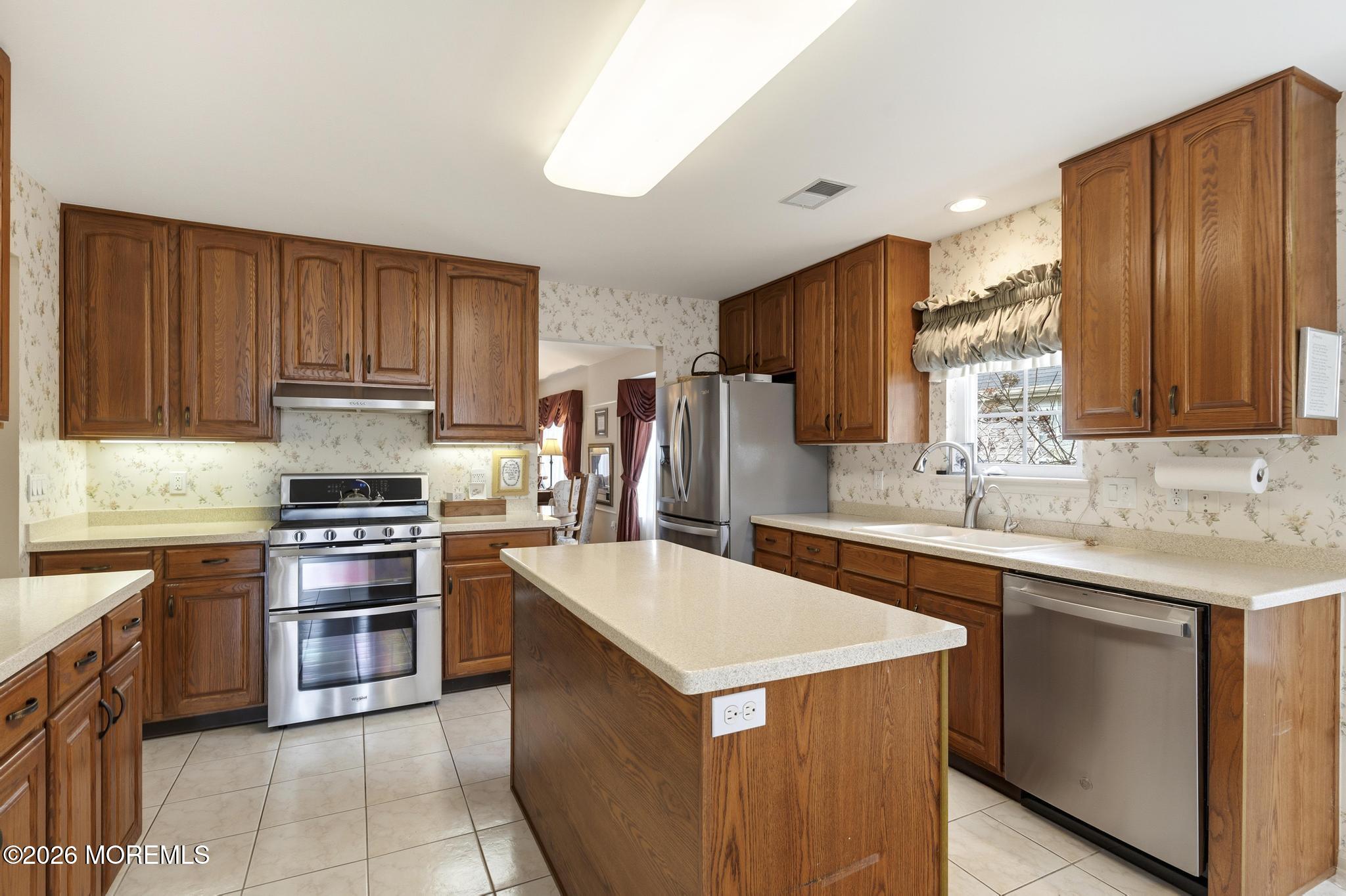62 Ivy Hill Road Lakewood, NJ 08701 - Photo 21 of 62 a kitchen with stainless steel appliances a sink stove and refrigerator