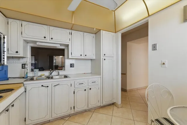 a kitchen with a sink cabinets and window