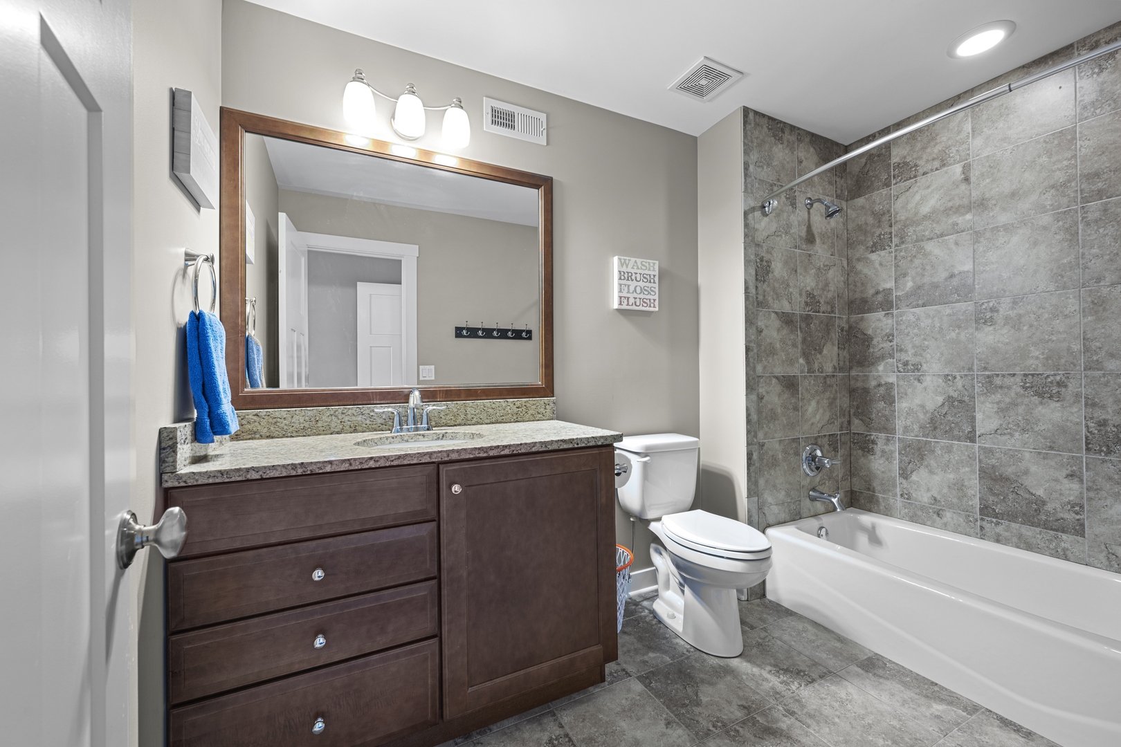 2035 Windham Circle Wheaton, IL 60187 - Photo 25 of 40 a bathroom with a granite countertop sink a toilet mirror and bathtub
