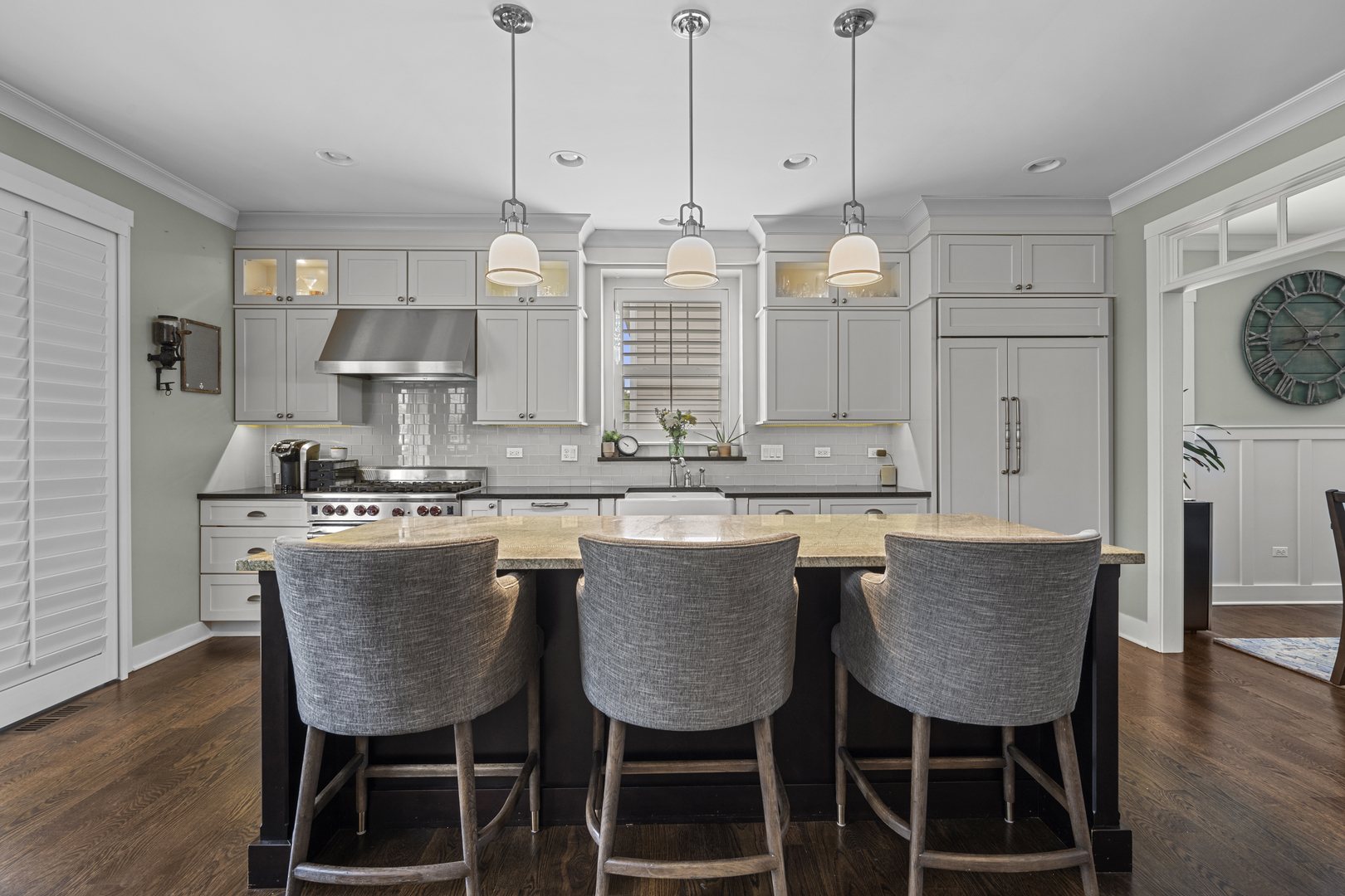 2035 Windham Circle Wheaton, IL 60187 - Photo 10 of 40 a kitchen with kitchen island granite countertop a table chairs a sink dishwasher refrigerator and cabinets