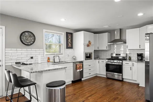 a white stove top oven sitting inside of a kitchen