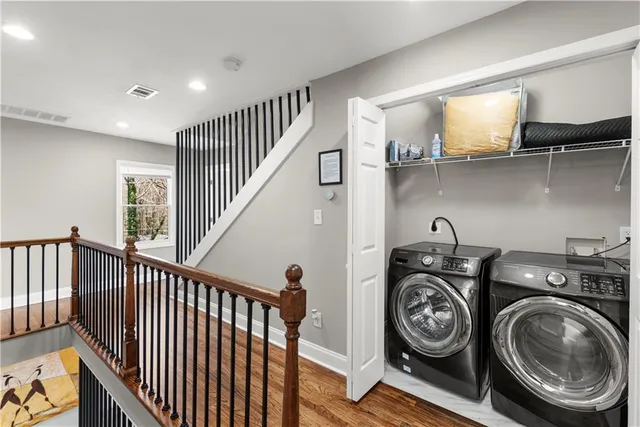 a view of staircase with wooden floor and a rug