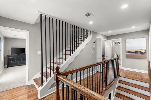 a view of a hallway with wooden floor and windows