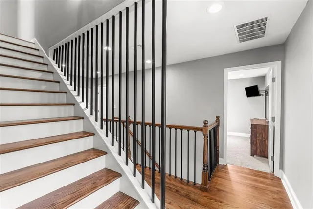 a bedroom with a large bed and a flat screen tv