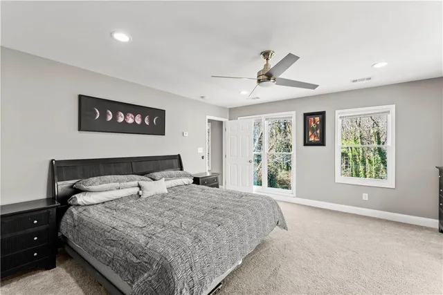 a spacious bedroom with a bed a couch and a window