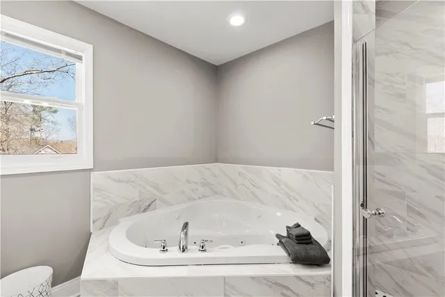 a bathroom with a granite countertop sink a toilet and shower