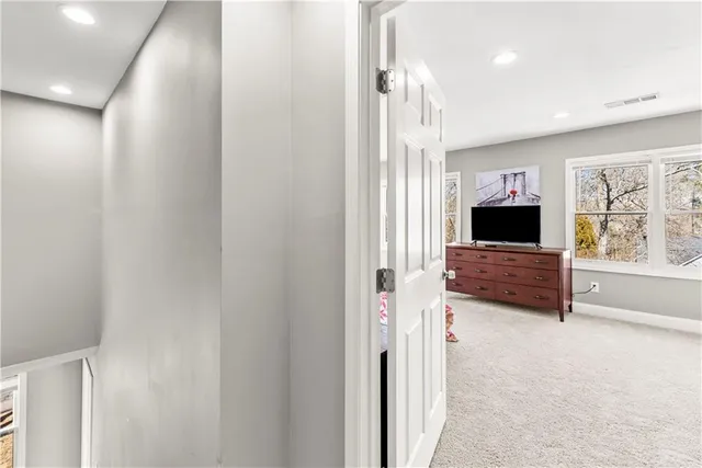 a bedroom with a bed and flat screen tv