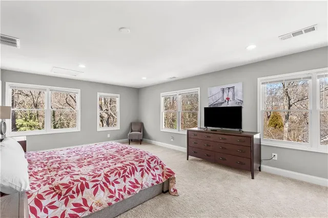 a spacious bedroom with a large bed and a window