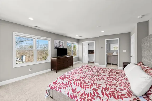 a bathroom with a granite countertop sink a mirror and shower